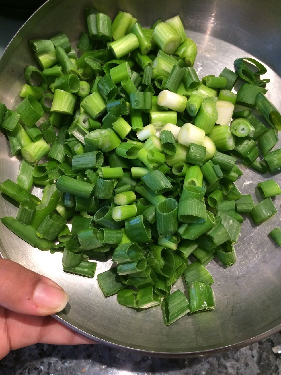 Chop up some spring onions for topping of enchiladas.