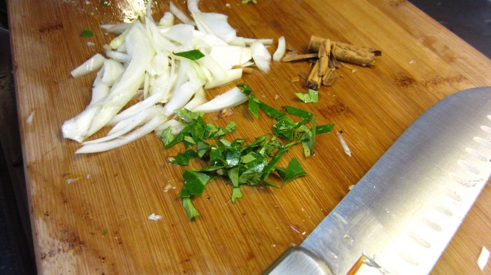 Chop up the onion, finely chop up the curry leaves and break the Ceylon Cinnamon stick into two. The Ceylon Cinnamon gives this dish a fabulous savory taste and blends well with the Cabbage.