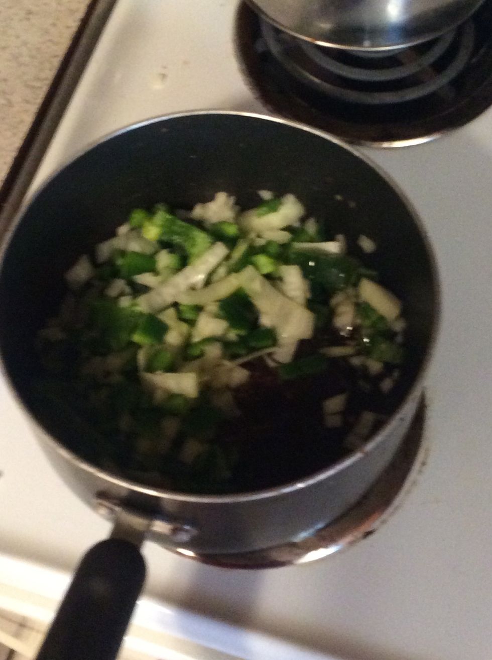 Chop up the onions and peppers on high and cook until onions are transparent.