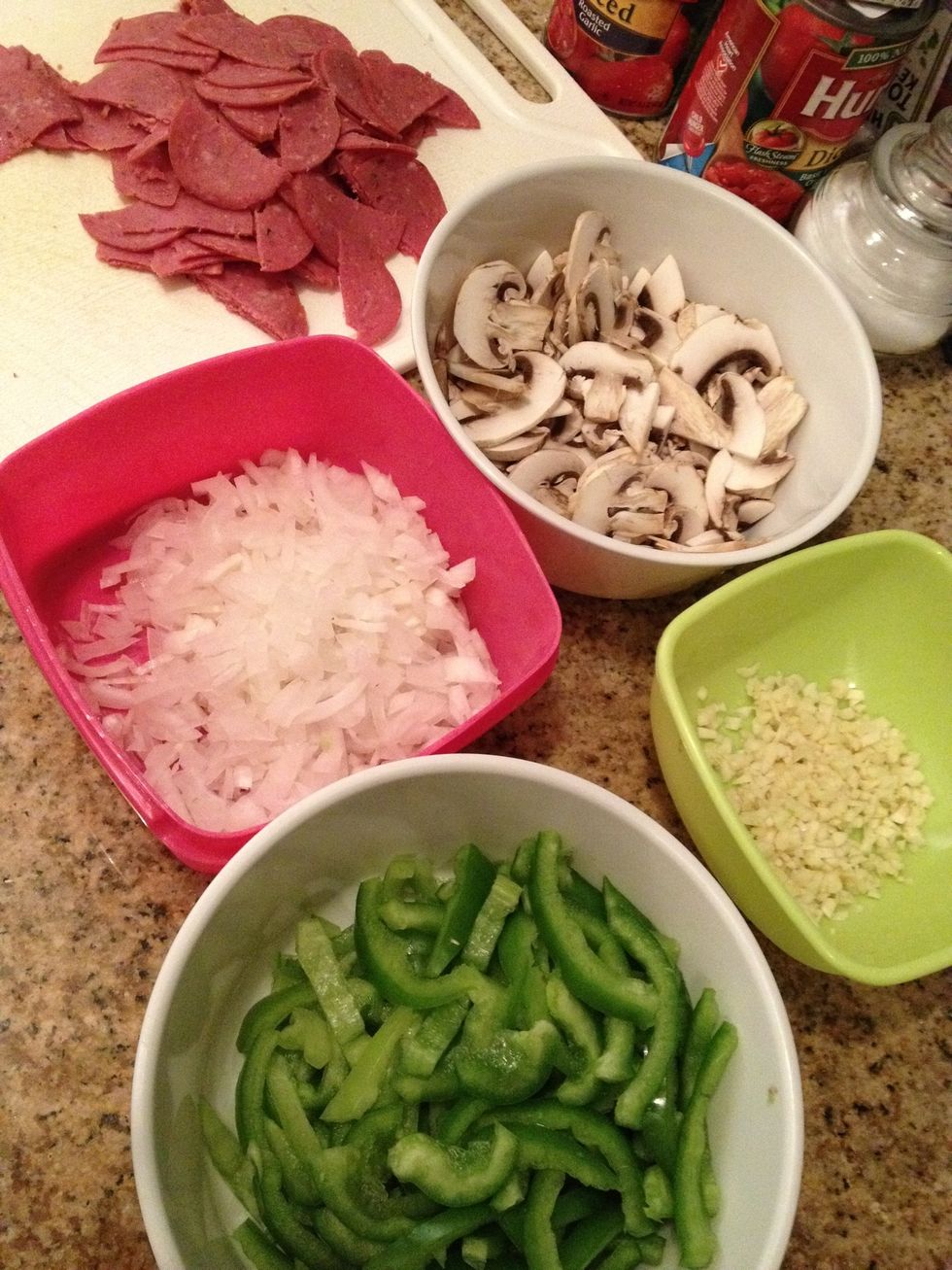 Chop up the veggies and toppings. The onion and the garlic are for the sauce, the rest are toppings. Add or substitute your favorite toppings as you wish.