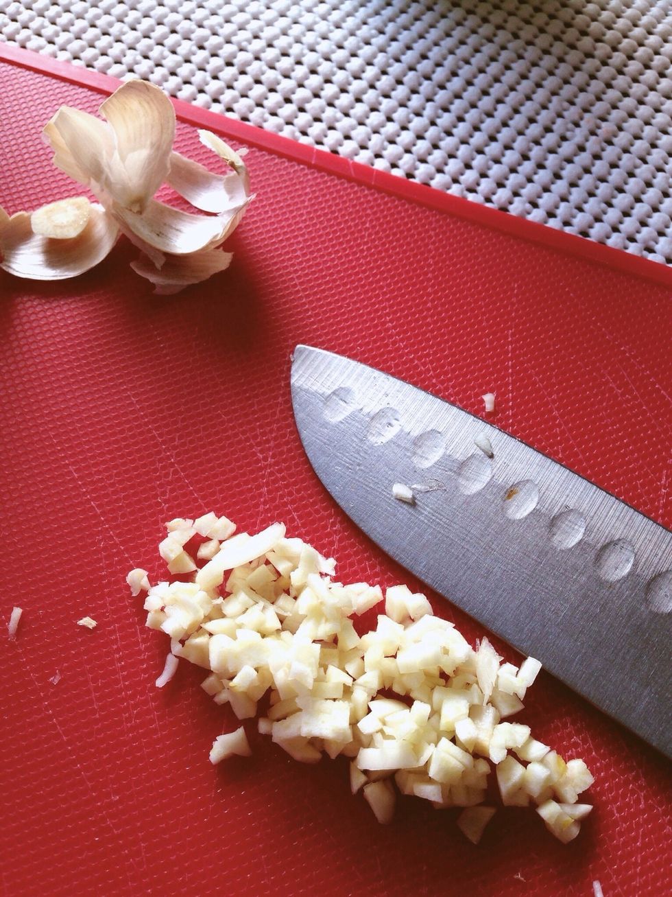 Chop up your garlic clove into tiny pieces. We're going to be using this in the marinade!