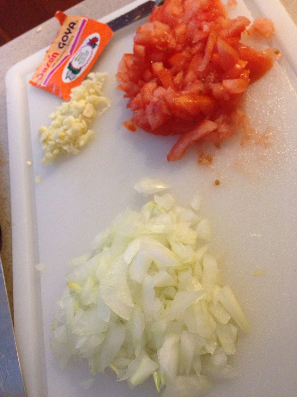 Chop up your garlic, onion & tomato...(Saz\u00f3n seasoning will be an added ingredient...)
