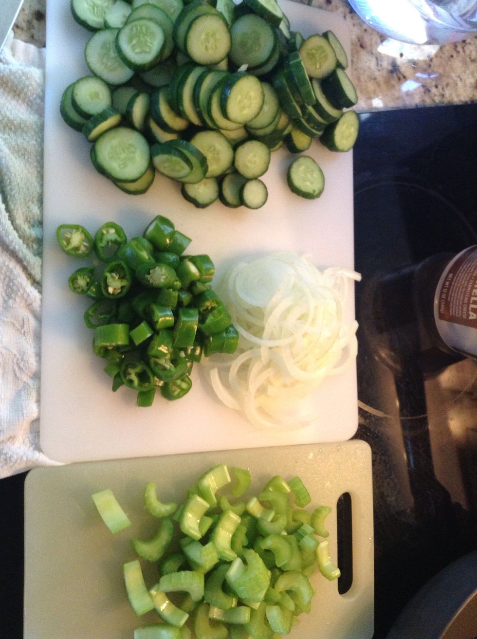 Chop up your veggies. When you're done, put your veggies into a glass jar. I like to put the veggies in a little bit at a time in an alternating pattern so everything is thoroughly mixed.