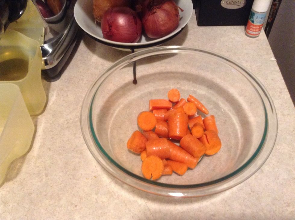 Chop your carrots. Taking off the tops is optional. Put them in the bowl first as you'll want them to run through the juicer last to clear out any soft fruit.