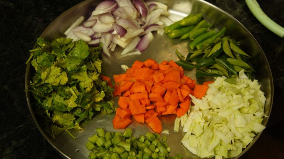 Chopped carrot, fresh beans, cabbage, curry leaves, coriander leaves, onion, chillies..