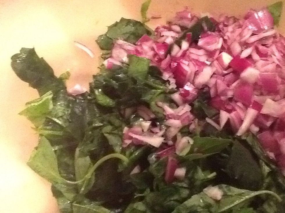 Chopped onion, basil and spinach with minced garlic for salad filling