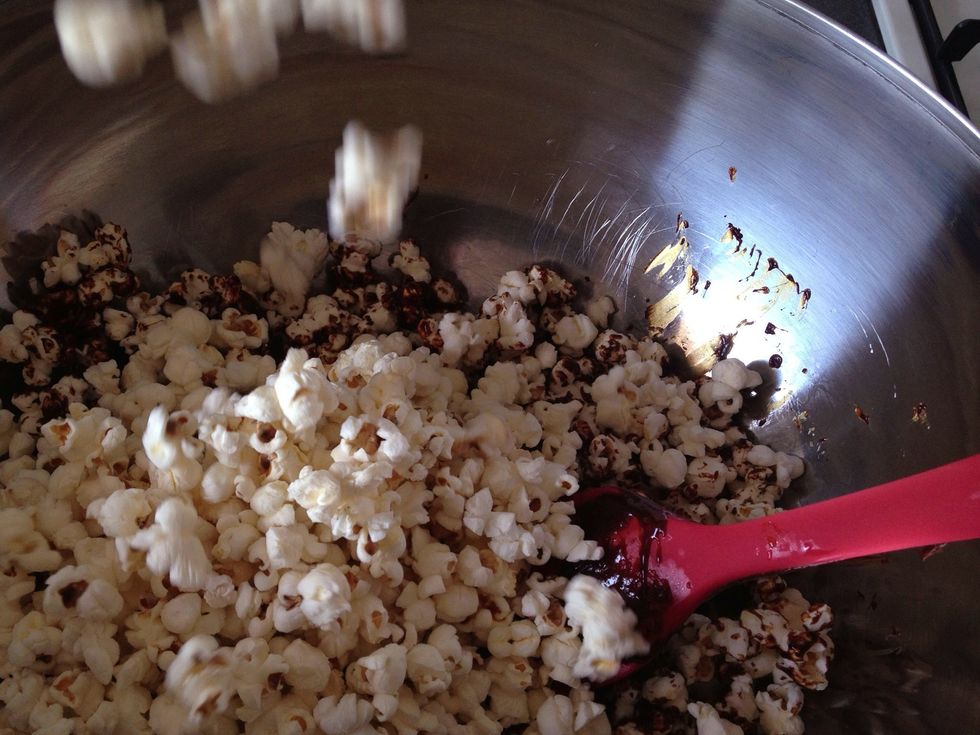 Chuck remaining popcorn from the other bowl into your working bowl then pour the remaining caramel and stir some more. Don't worry if all the popcorn isn't perfectly coated. Transfer to large tray.