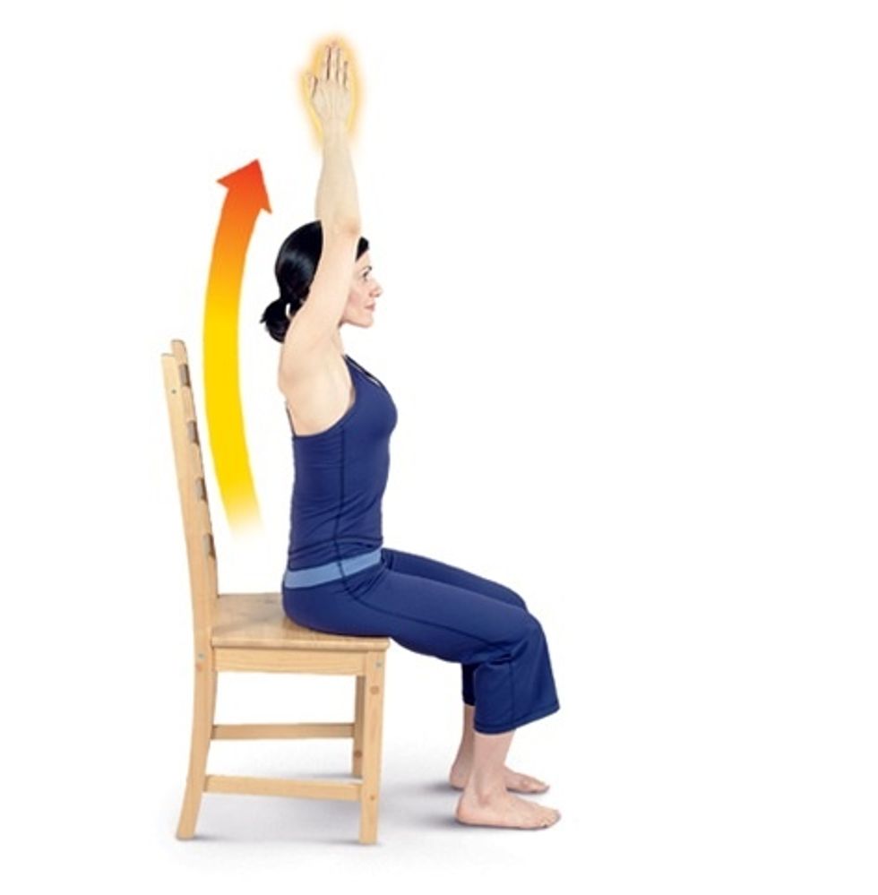 Circle your arms out to each side and then bring your palms together overhead to perform arm stretches.