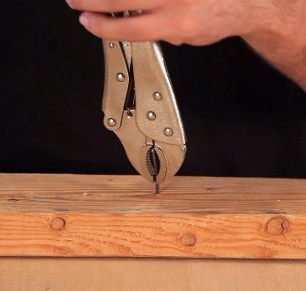 Clamp the vice grips onto the shank of the nail. Depending on how long the nail is, you may have to re-adjust the vice grips a few times.