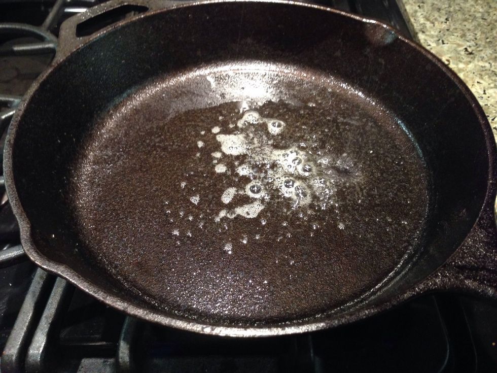 Clarified butter in a cast iron really tastes great while setting off smoke detectors. High smoke point oil works too.