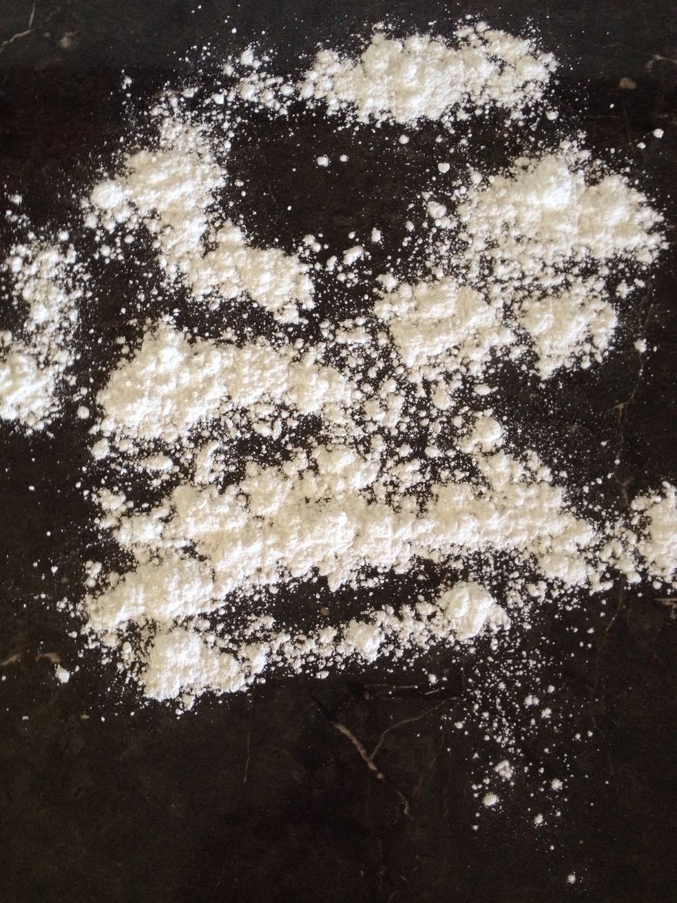 Clean all the cocoa powder off your bench and sprinkle it with icing sugar.