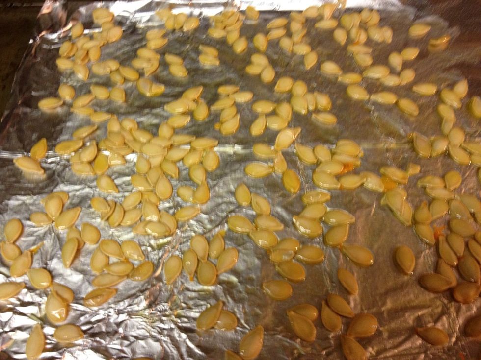 Clean and dry seeds, spread seeds on foil and coat with oil and salt. Cook 10 min at 300 F or until seeds split and are crispy.