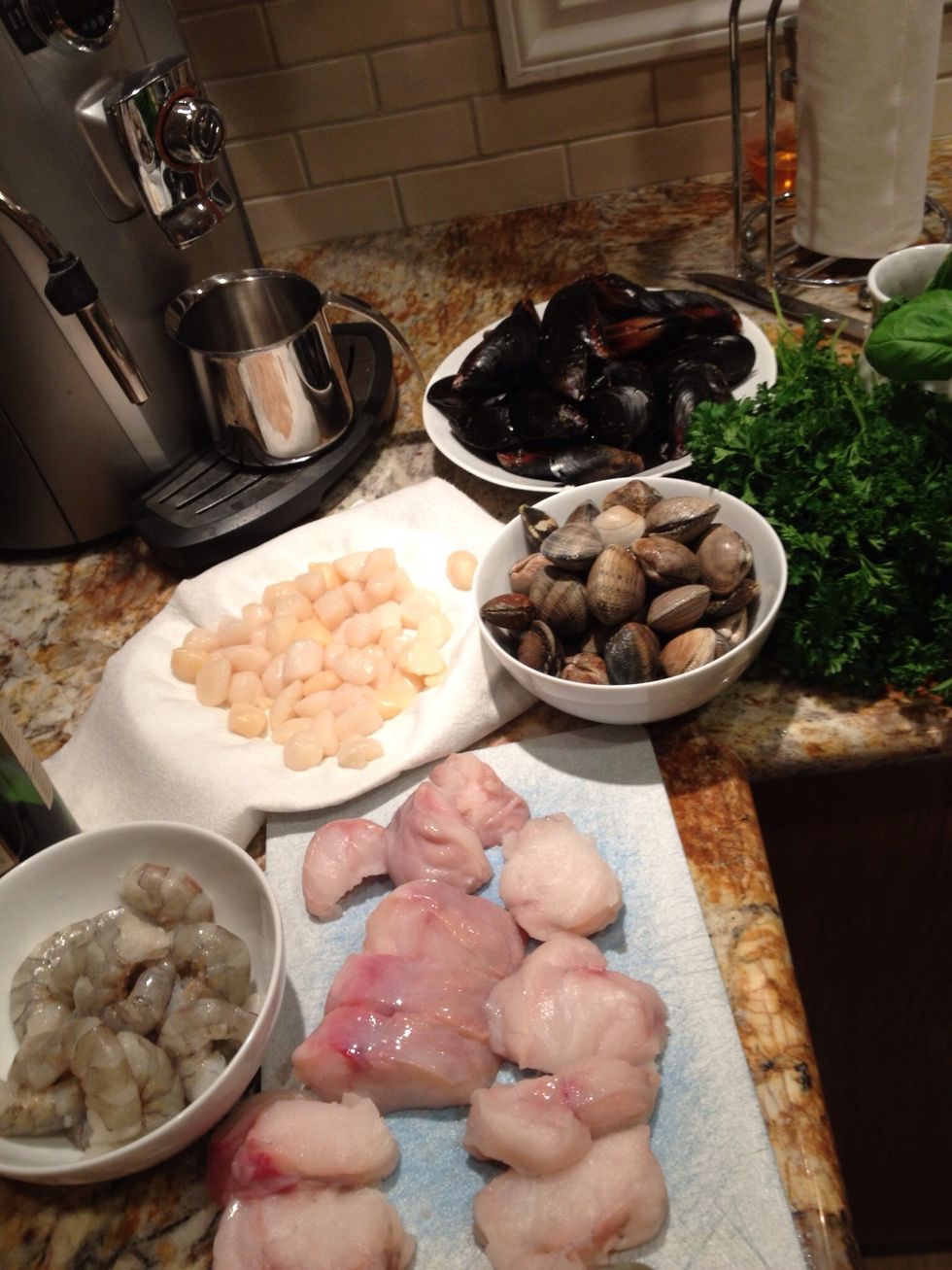 Clean and prepare seafood. The seafood doesn't take very long to cook so simmer sauce for a while and then add seafood 15 minutes prior to serving.