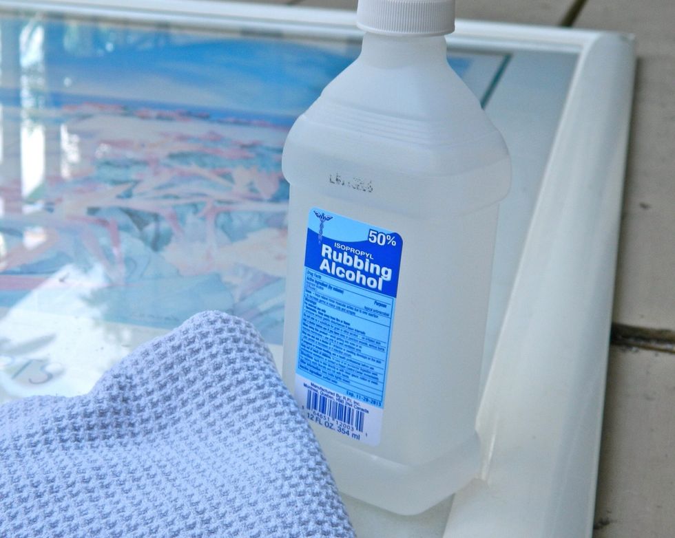 Clean frame and glass with rubbing alcohol.
