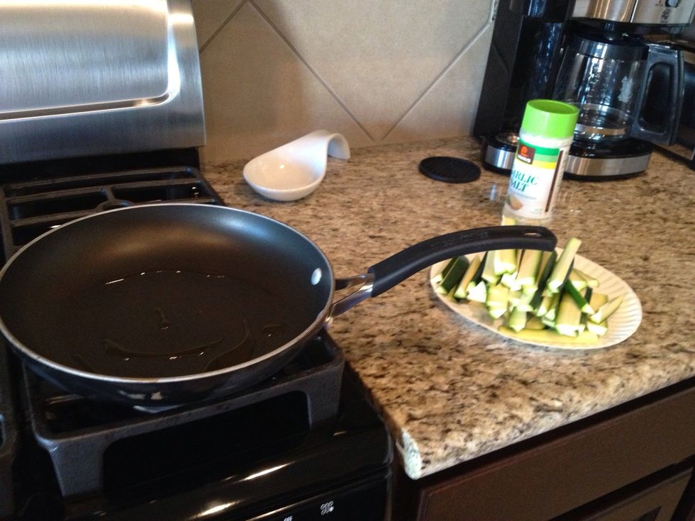 Clean frying pan and add olive oil for zucchini.  I like to season with garlic salt but that is up to you :)