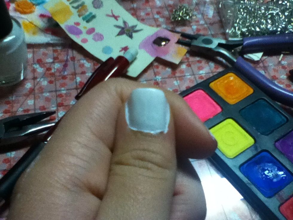 Clean off bear nail with rubbing alcohol then paint on 2-3 coats of white.