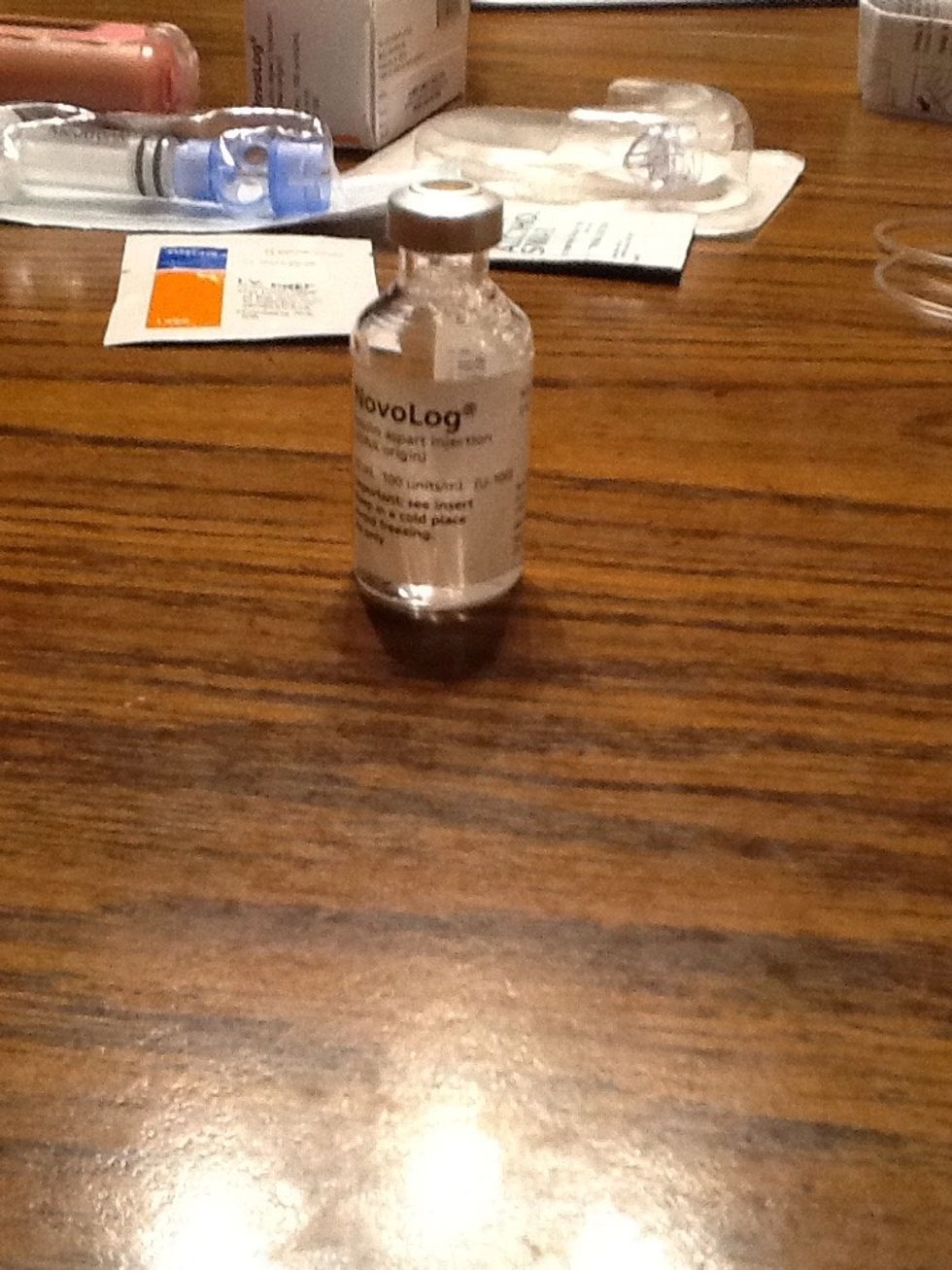 Clean off insulin bottle with alcohol wipe