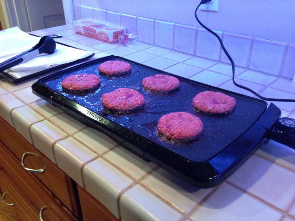 Clean out half or most of the bacon grease then fry burgers in remaining grease for about 5 minutes per side or until browned on each side.