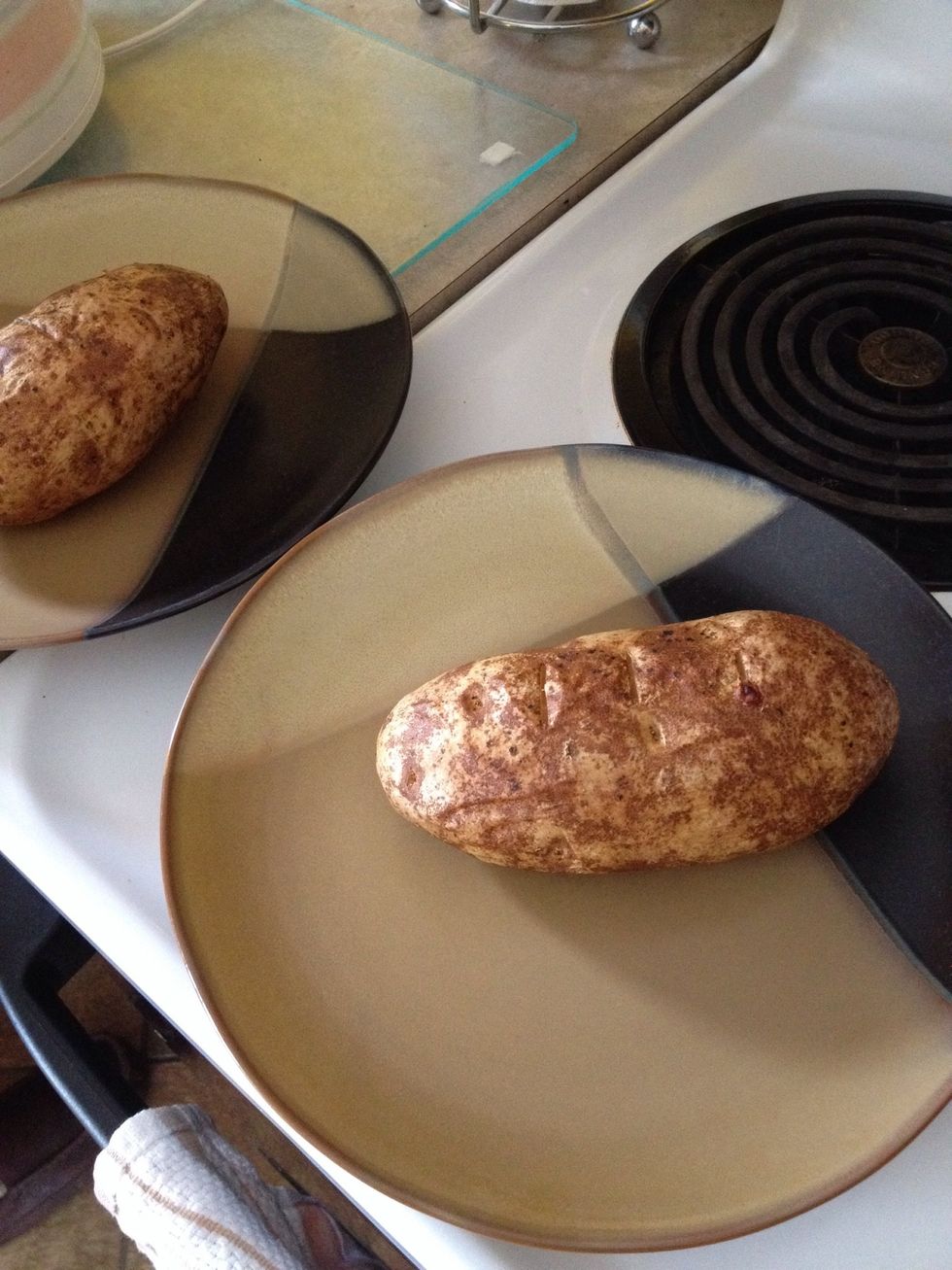 Clean & stab potatoes with a fork or knife a few times on each side. Rub w/ olive oil. Bake until soft. For baked potato perfection see this site - http://whatscookingamerica.net/Q-A/PotatoBaking.htm