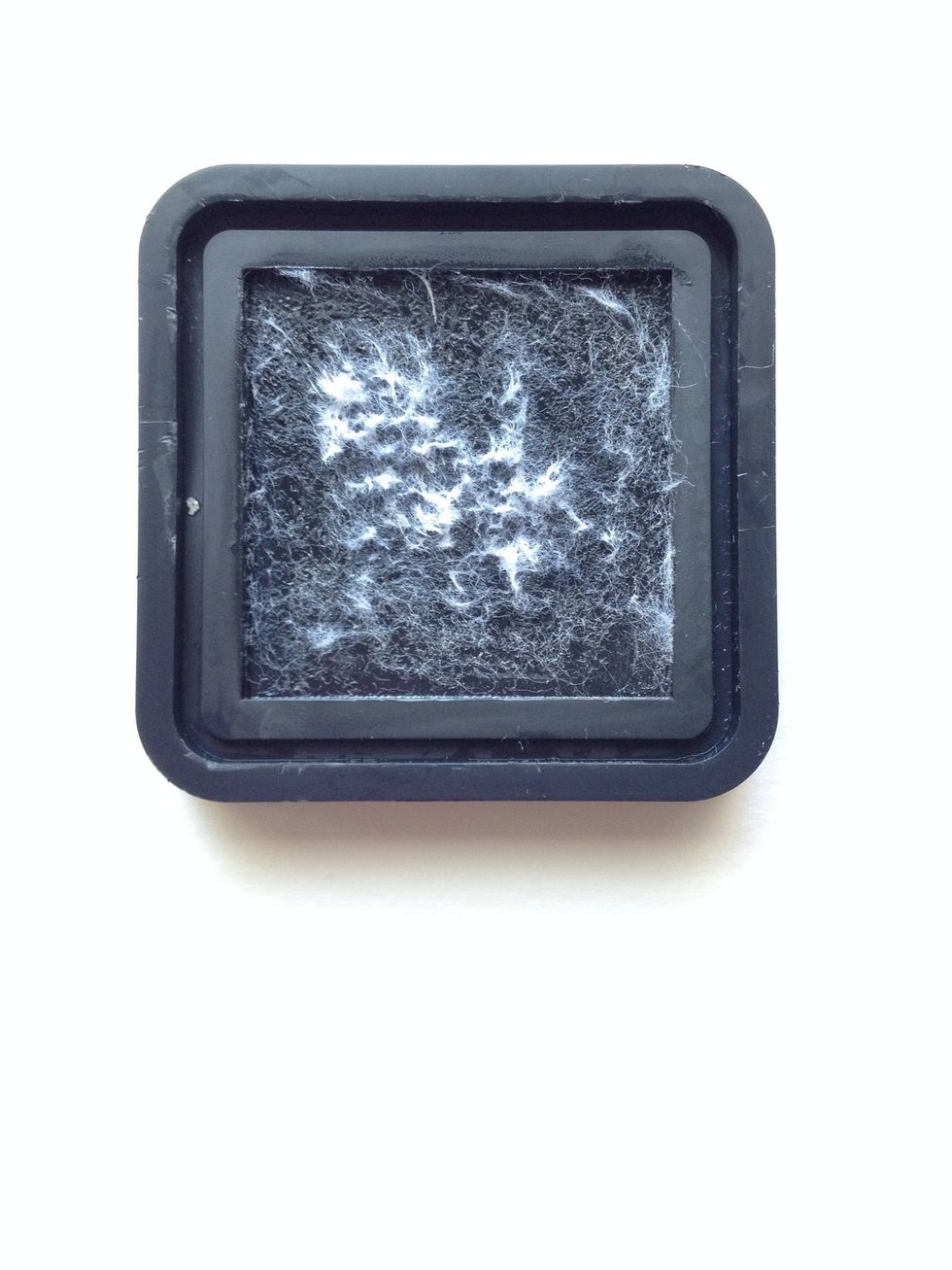 Clean the base of your ink pad with warm water and soap. Again, don't worry too much about the fibers.