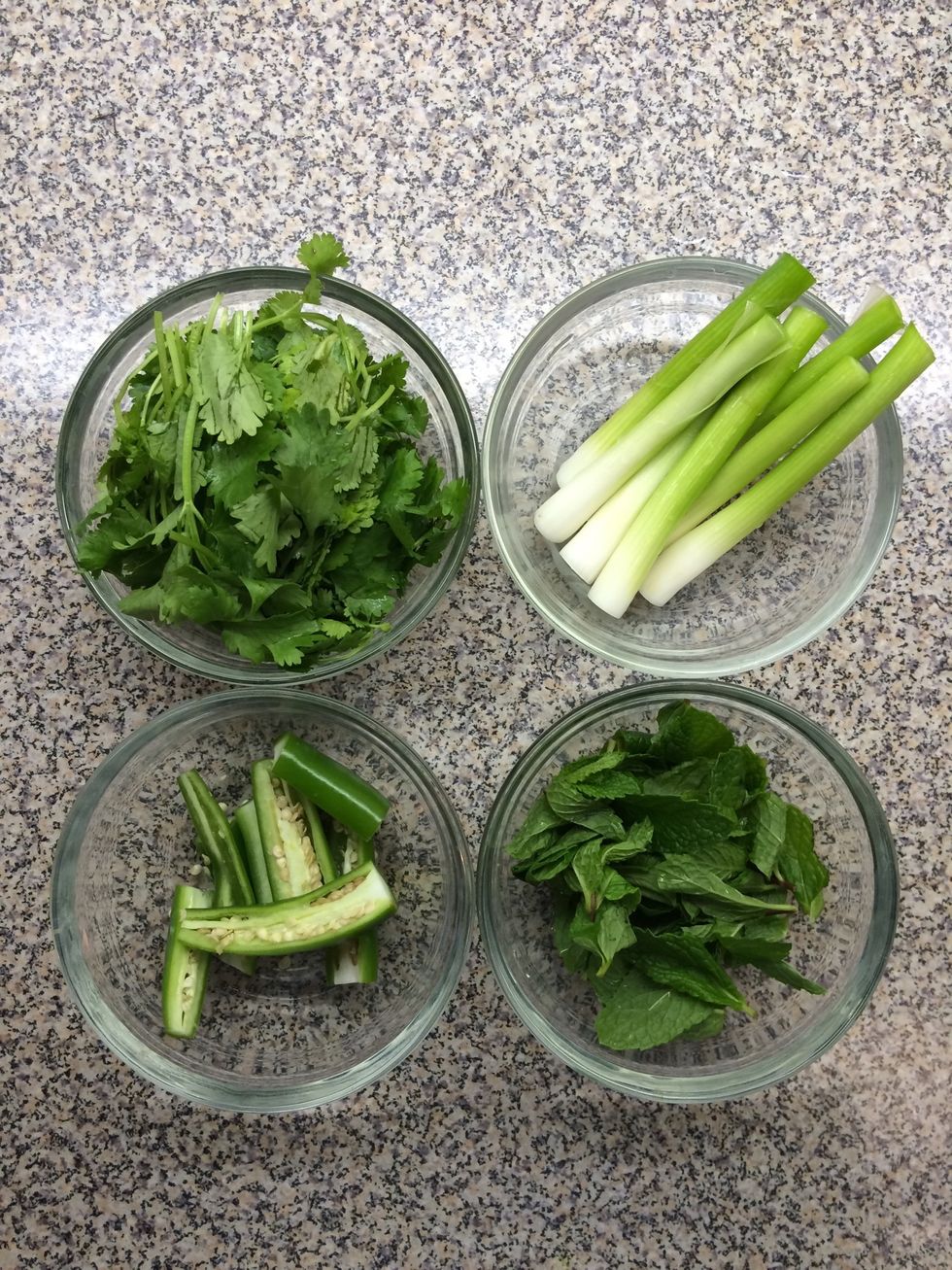 Clean the cilantro, mint and green onions. Chop the serrano chili peppers into halves.