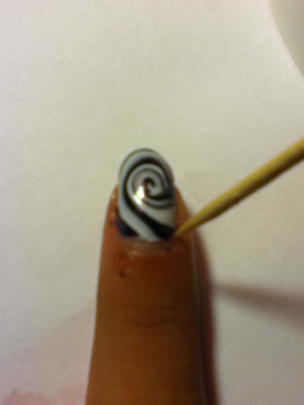 Clean the corners of the nail with a toothpick before it drys