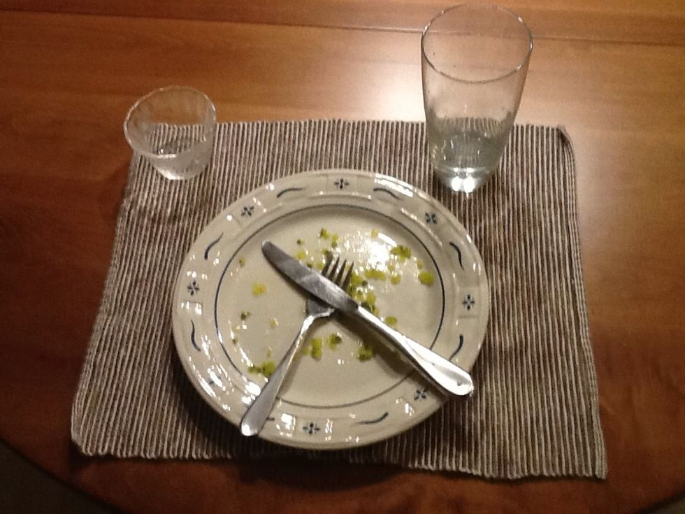 Clean the dishes off the table and put them in the sink.