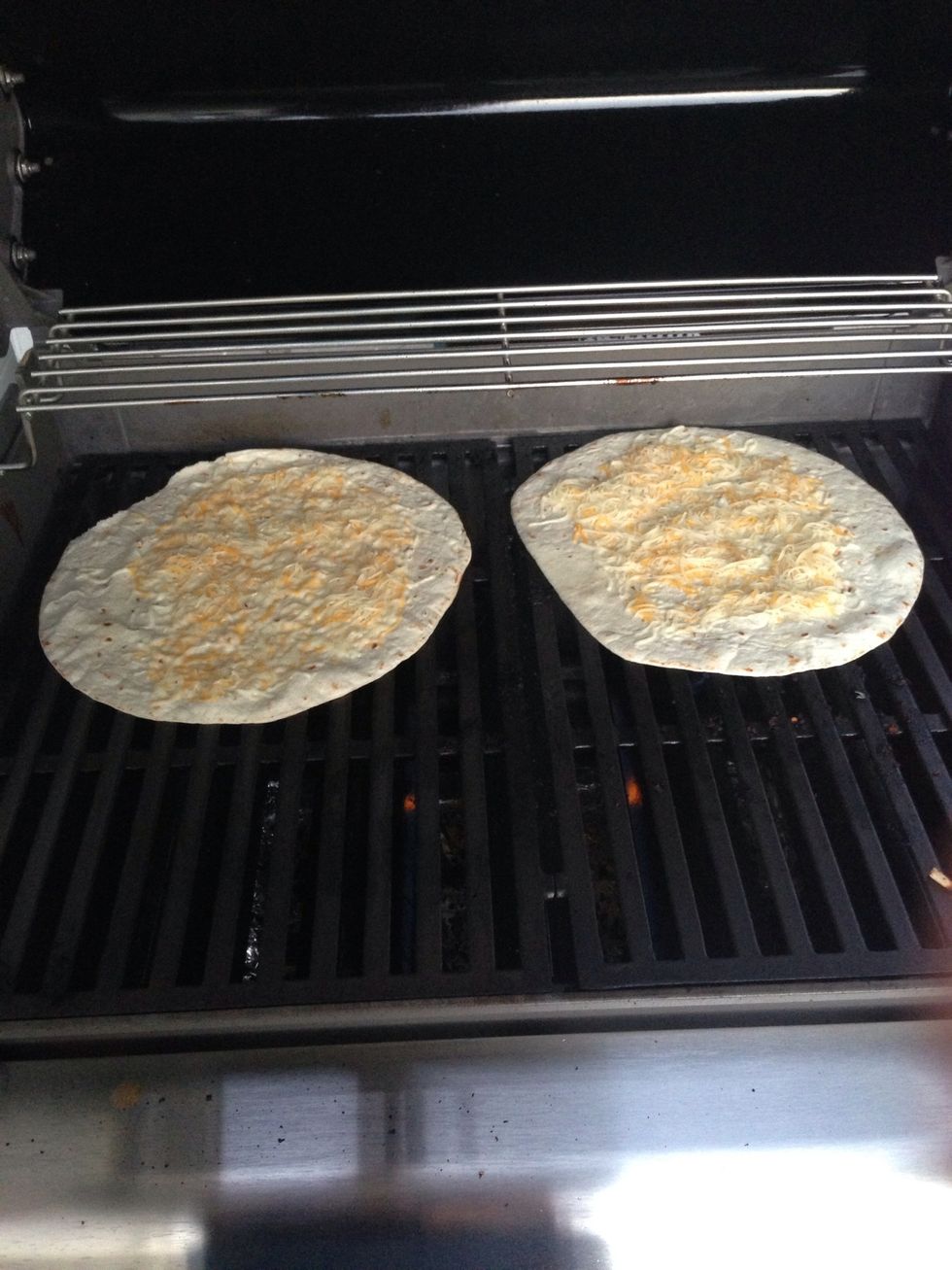Clean the grill off and put the quesadillas on the grill. You can either close the grill or leave it open. Cook the tortillas for 3 mins or until cheese is melted.