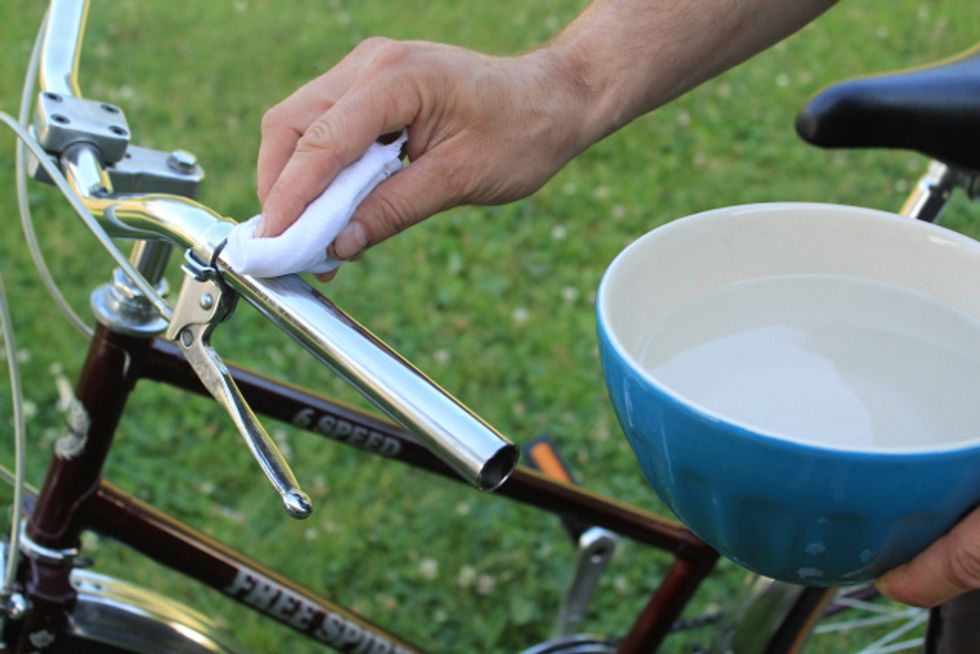 Clean the handle bar with soapy water or alcohol.  Use a fine abrasive material if much residue is present.