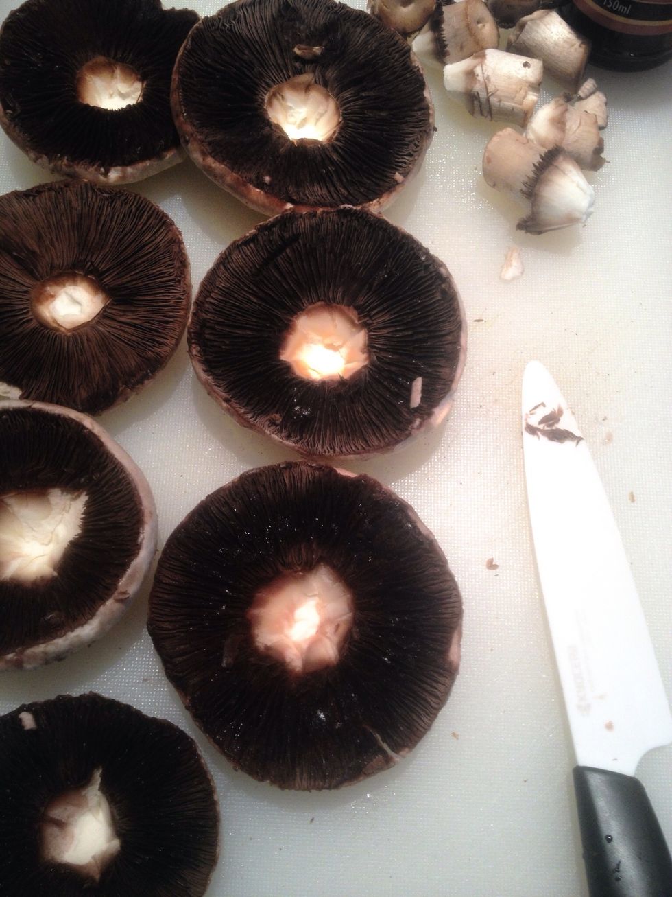 Clean the mushrooms with a wet cloth and de-stalk them so they'd have a hollow middle. Dry them off as much as you can with a paper towel then slice them in half.