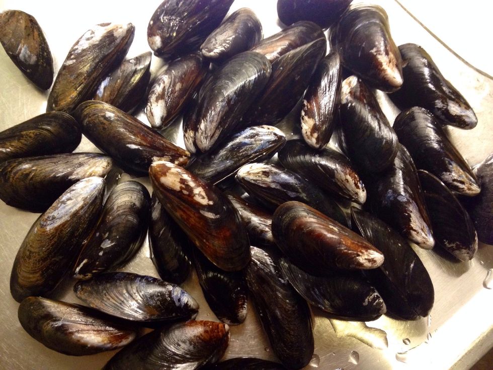 Clean the mussels according to the instructions; use a brush to remove dirt etc from the shells. Throw away any mussels not closing the shell while tapping them.