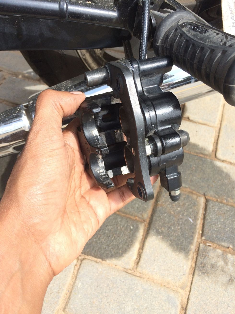 Clean thoroughly and wait for the caliper to dry. Wipe down and spray very little WD40 to displace water and lubricate the unit. Wipe off extra lubricants and cleaning fluids