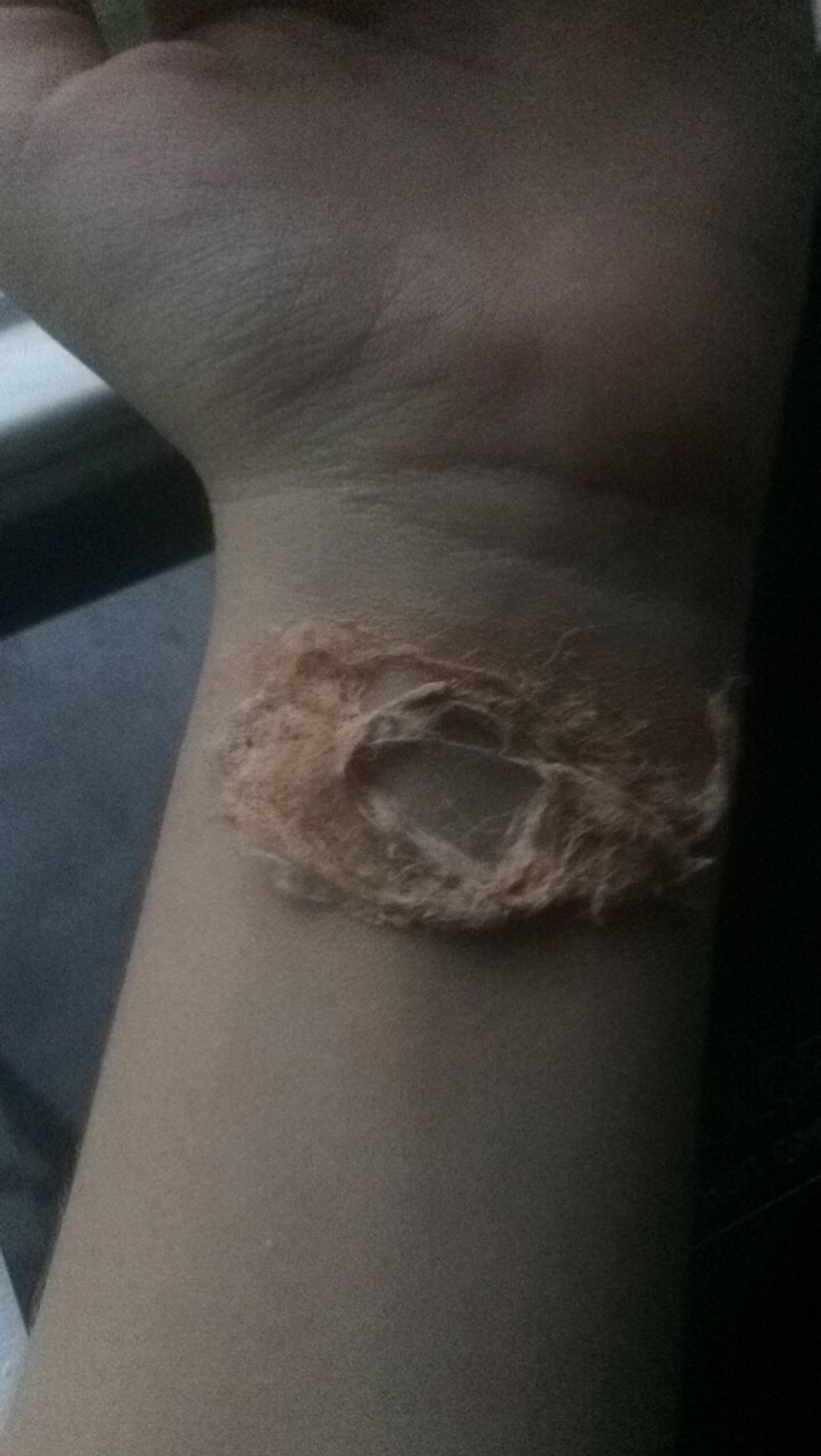 Clear a hole in the mixture on your wrist.