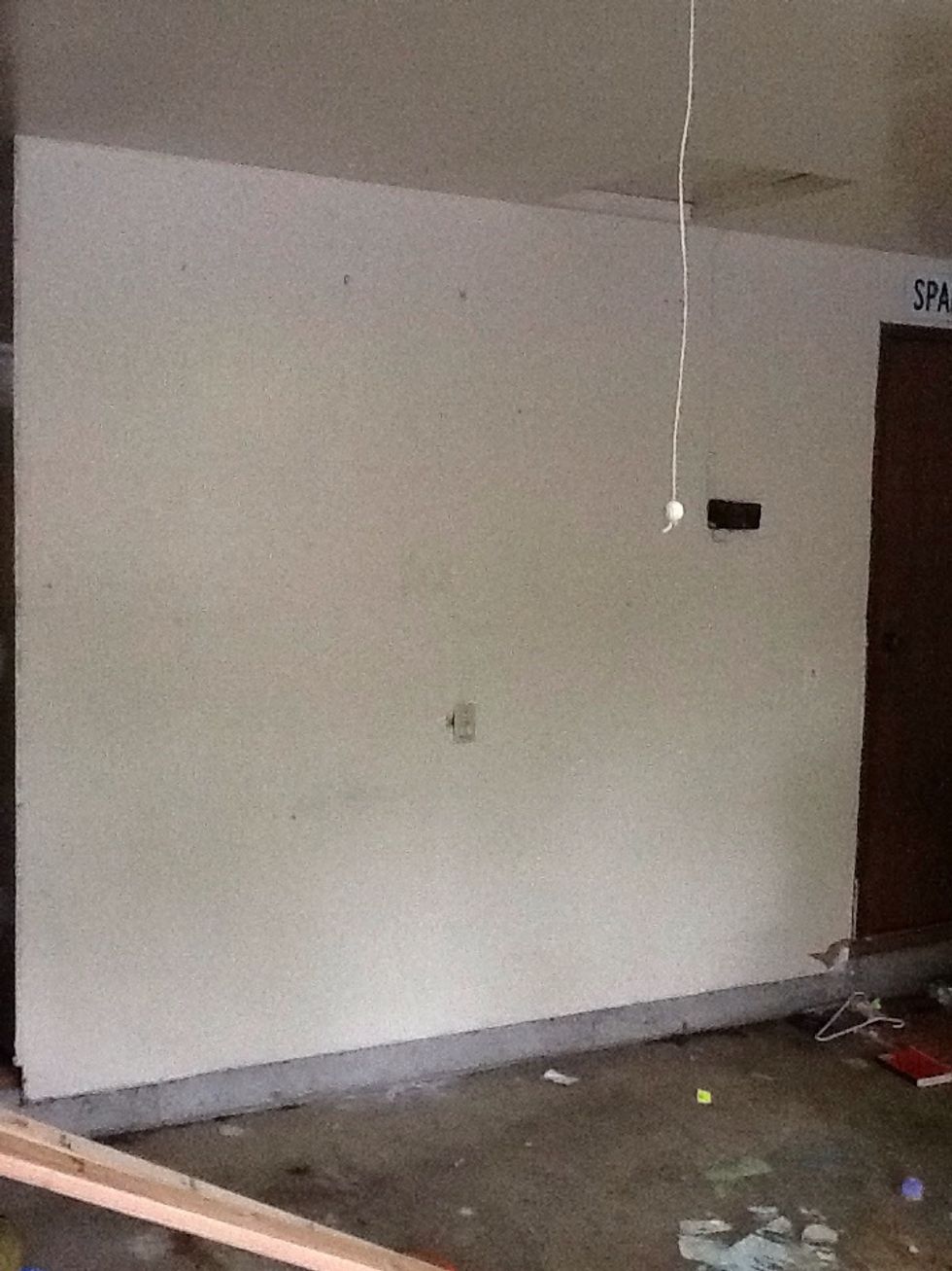 Clear and measure a wall in your garage, making sure there is adequate room for the shelving unit.