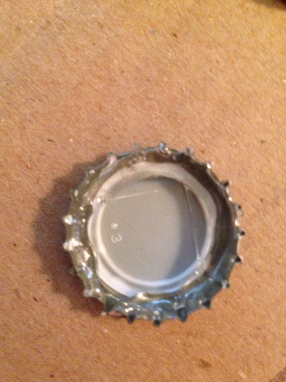 Clear off your coaster, heat up that glue gun and carefully squeeze glue around the INSIDE of the cap. The cap will get hot so be careful!