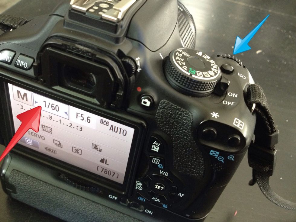 (click on photo and zoom out to see full image) you change the shutter speed by adjusting the dial by the shutter button.
