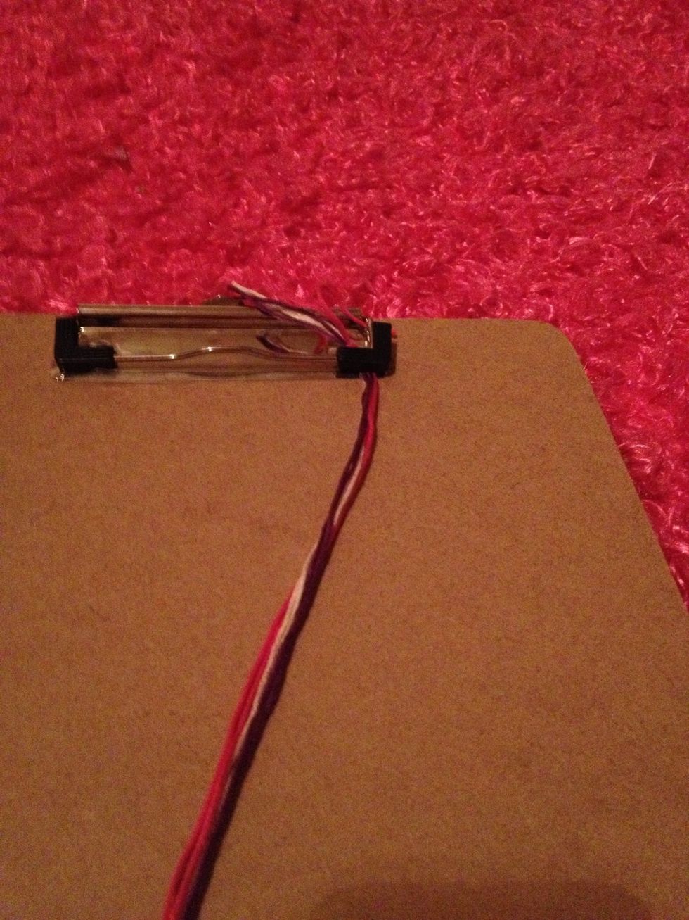Clip it under a clipboard on close a drawer on it so it stays