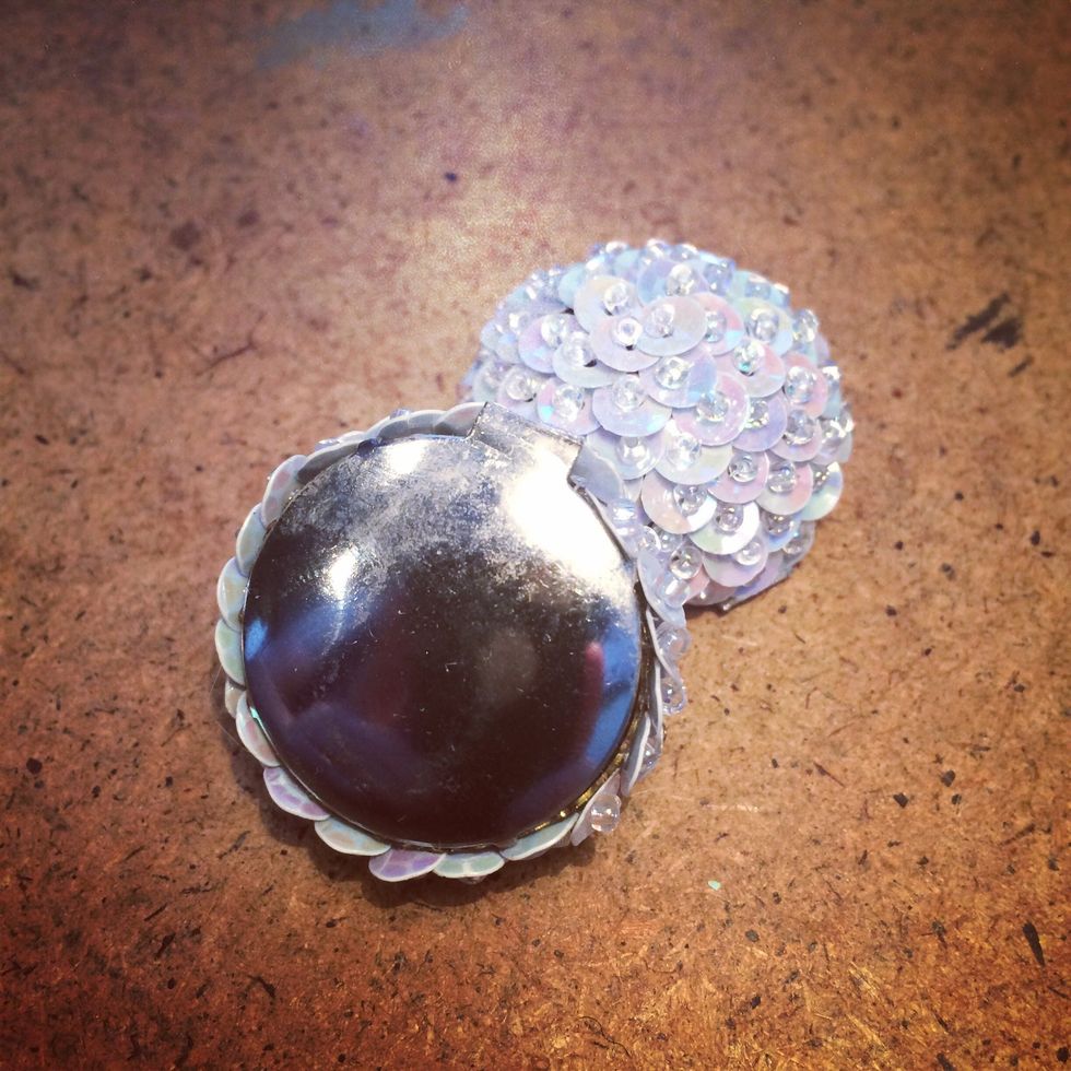 Clip on earrings are perfect for repurposing projects. I used my pliers to cut off the clip on part of the back of the earring. Easy peasy! Now I have a flat surface to adhere to the drawer pulls.