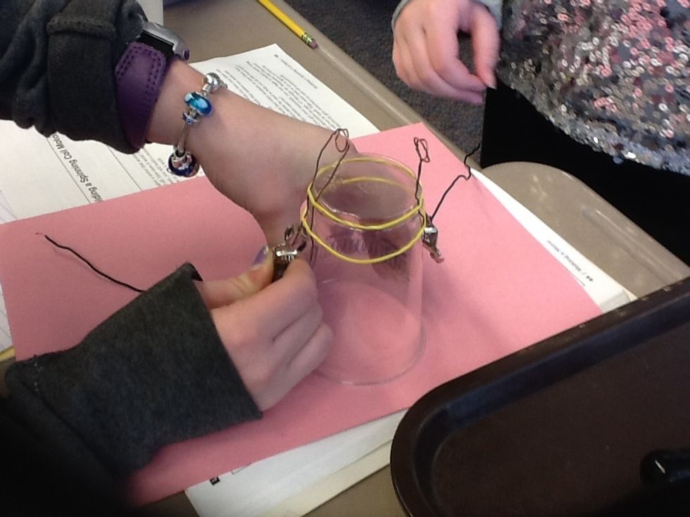 Clip the alligator clip to the bare copper wire.