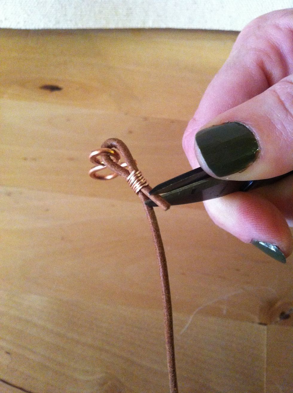Clip the end of the leather so just a short bit hangs below the coil.
