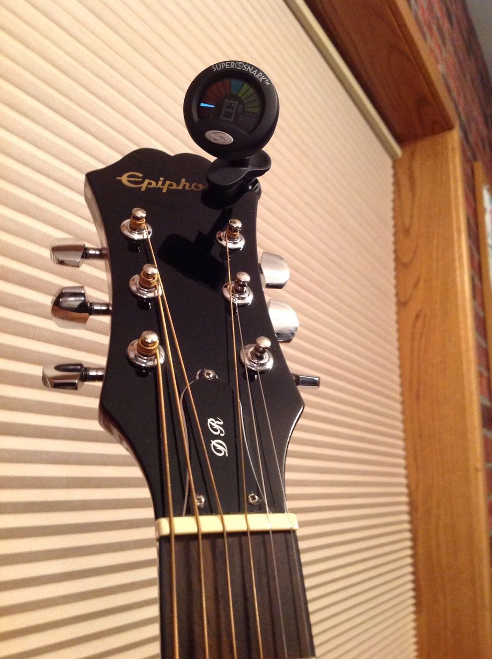 Clip the tuner on to the guitar.