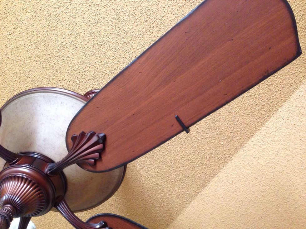 Clip the weight onto center of one edge of blade. Turn fan on to see if this eliminates wobbling. If not, move the clip to the next blade and try again. Keep trying on each blade until balanced.