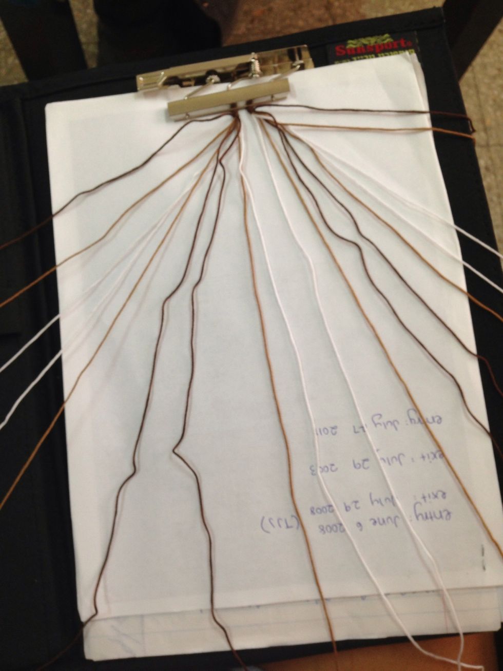 Clip your bracelet and spread the strings out in the order that the pattern shows. For the first 3 ROWS we're going to keep it spread out and annoying like this, and make sure you keep it organized!!