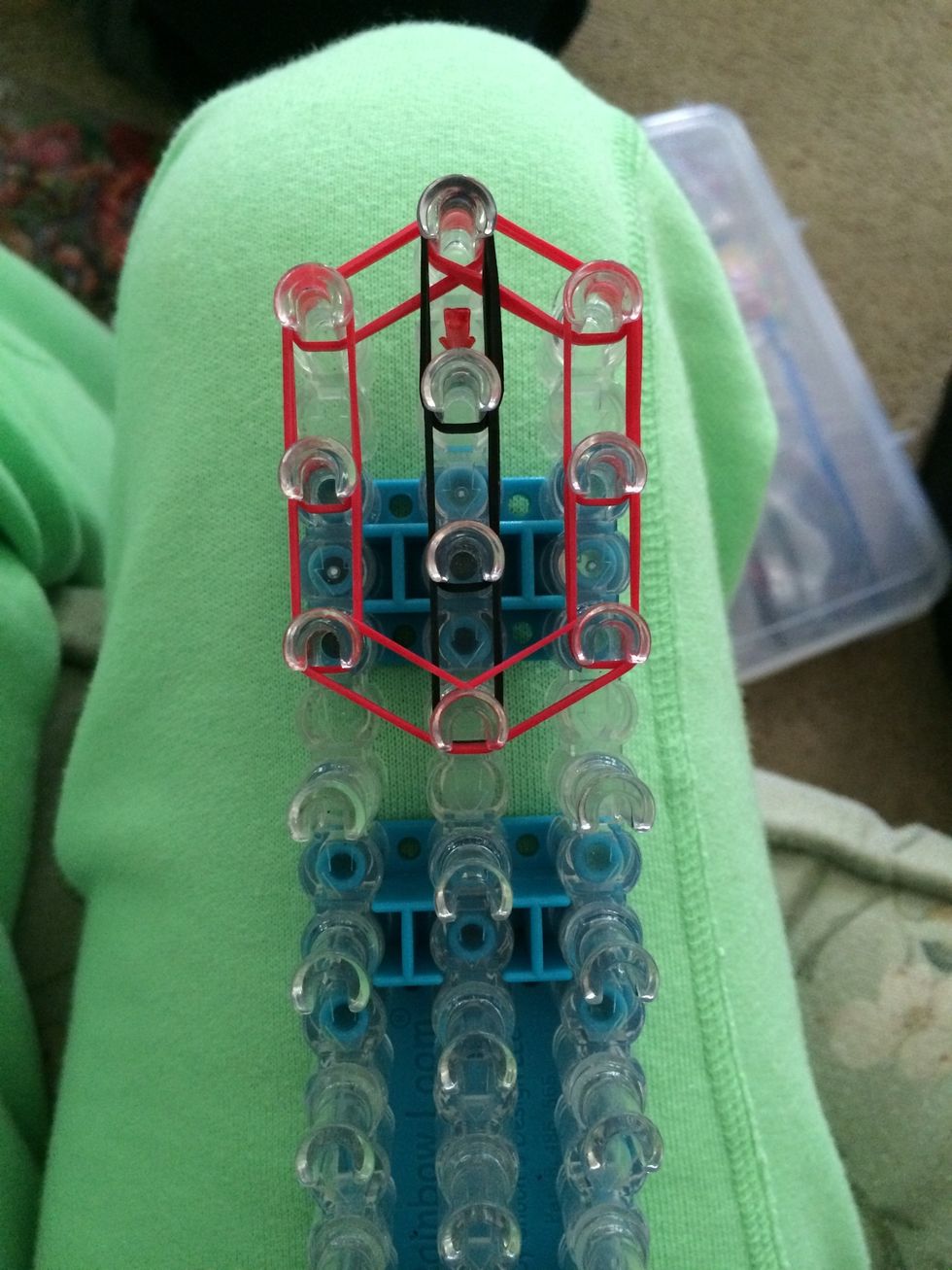 Close off the top part of the tie by placing 2 sets of red rubber bands from the left to the center and from the right to the center.