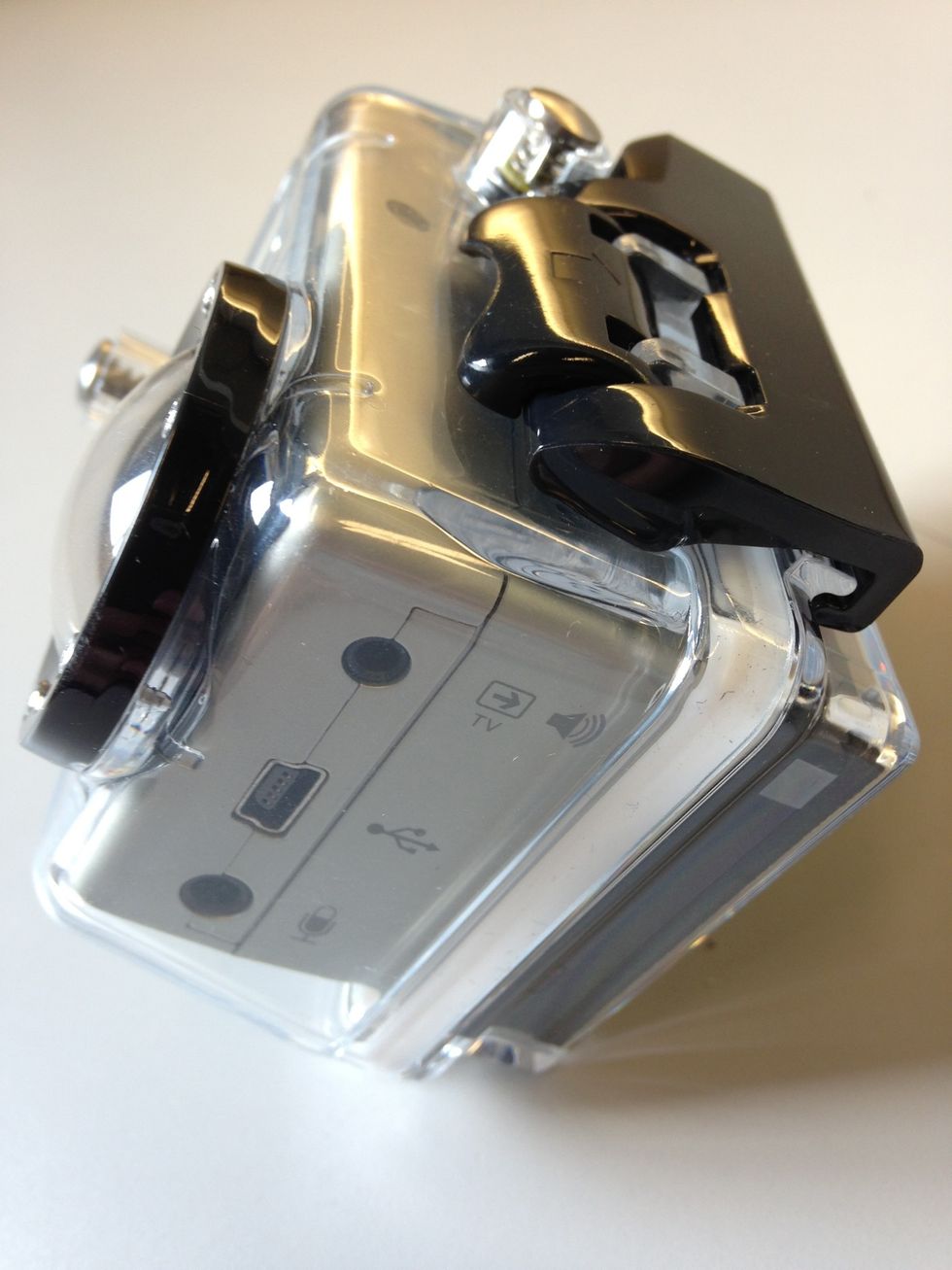 Close the back of the case, flip the black latch over both cases and push the black tab with the arrow down. You should heard a snap when the case is secure.