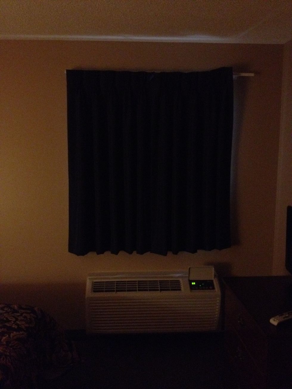 Close the curtain. A wee little bit of light may come through. That's ok, even at night I don't know anyone who sleeps with absolutely no light.