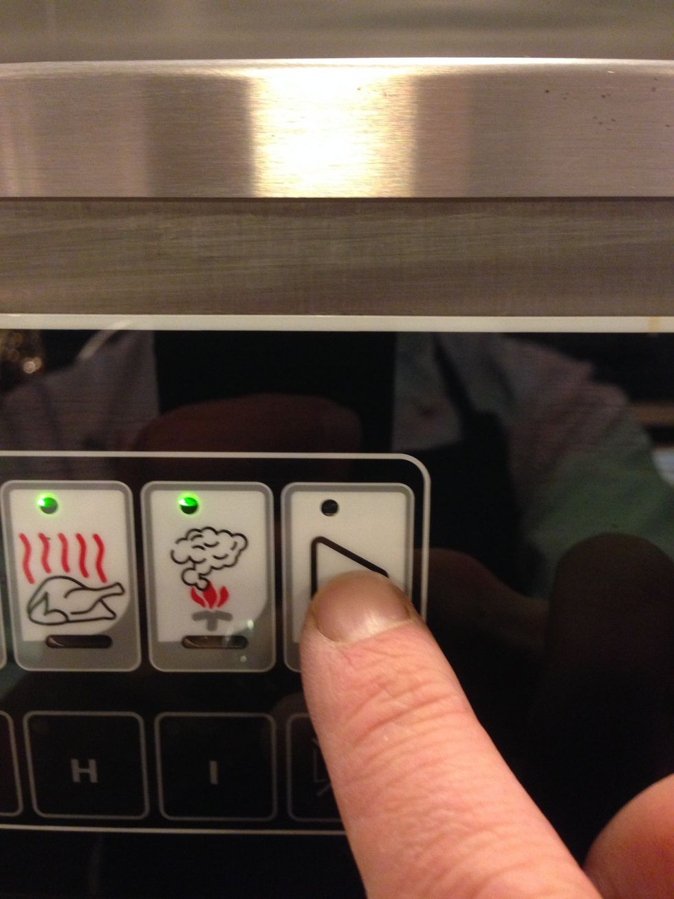 Close the door and press the "Start" arrow to begin the smoking and cooking process.