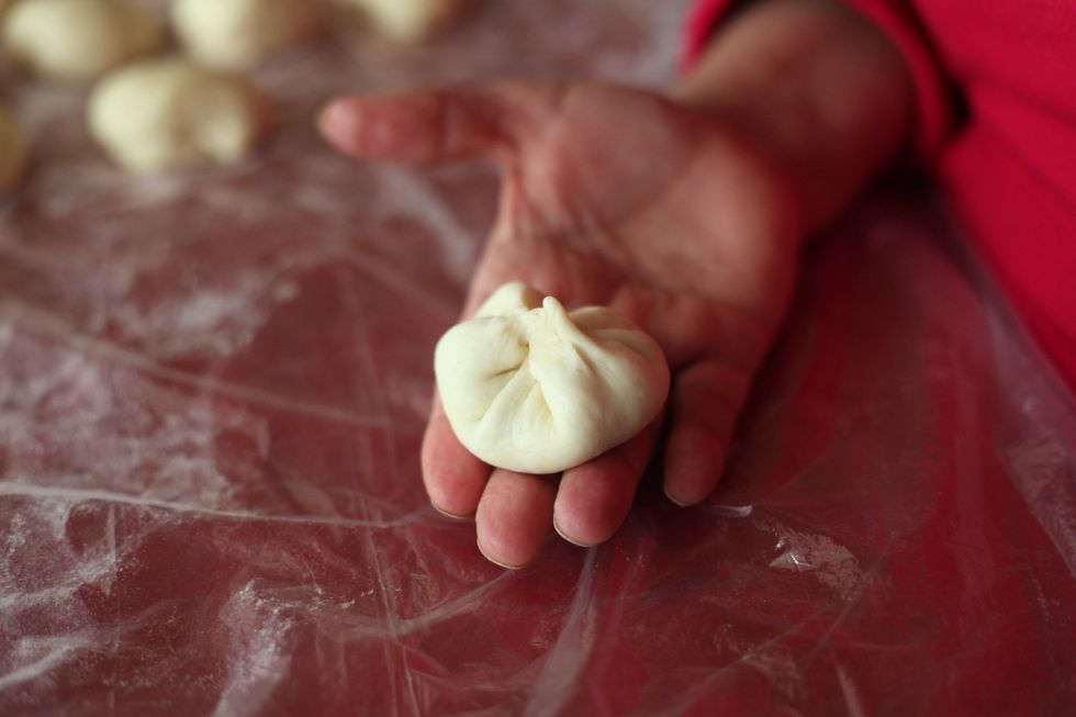 Close the dough off by gently pinch twisting the top. Don't stress too much, no one will see how bad the pinch is if you make a mess. They're all facing down anyway. *bows* genius here! Hahahaha