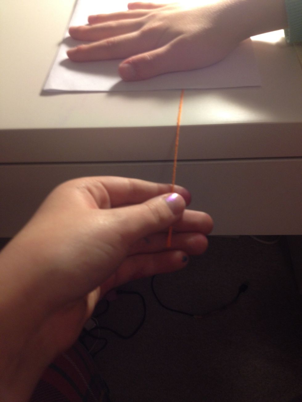 Close the paper a pull the string holding the paper flat firmly. You may want help from a friend.