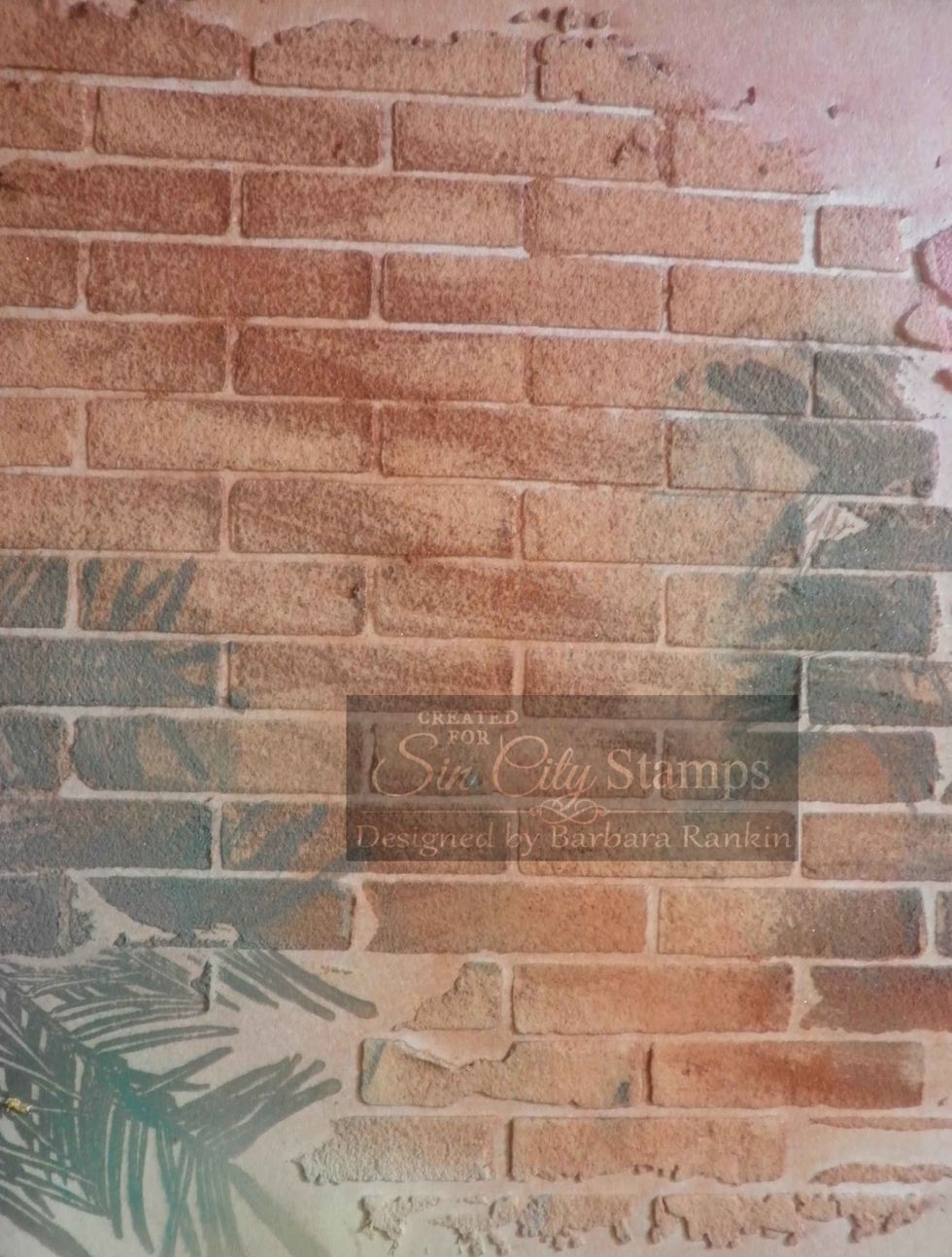 Close-up of stamped pine bough over brick stenciled areas.